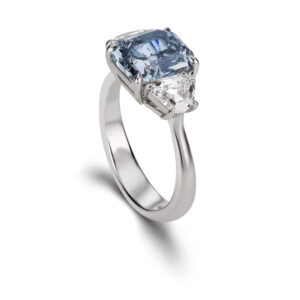 3 carat fancy intense blue diamond on a platinum band with two white diamond side stones